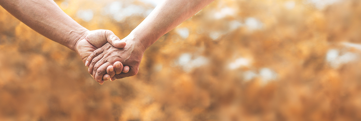 Senior couple holding hands together over nature background. featured service banner