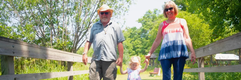 Grandparents take granddaughter for a walk