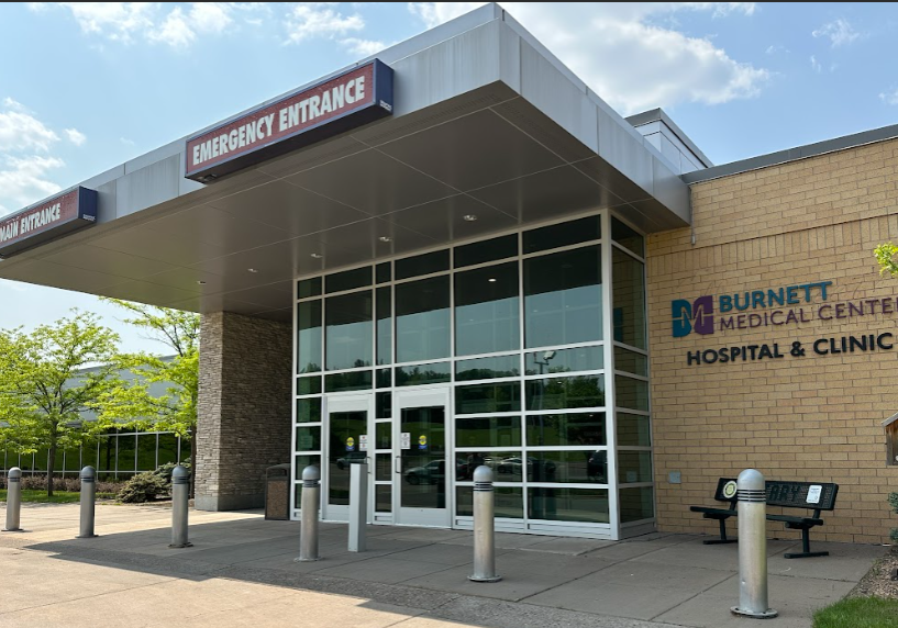 Burnett Medical Center entrance featuring "Emergency Entrance" and "Main Entrance" signs, showcasing the hospital's commitment to community healthcare in Grantsburg, WI.
