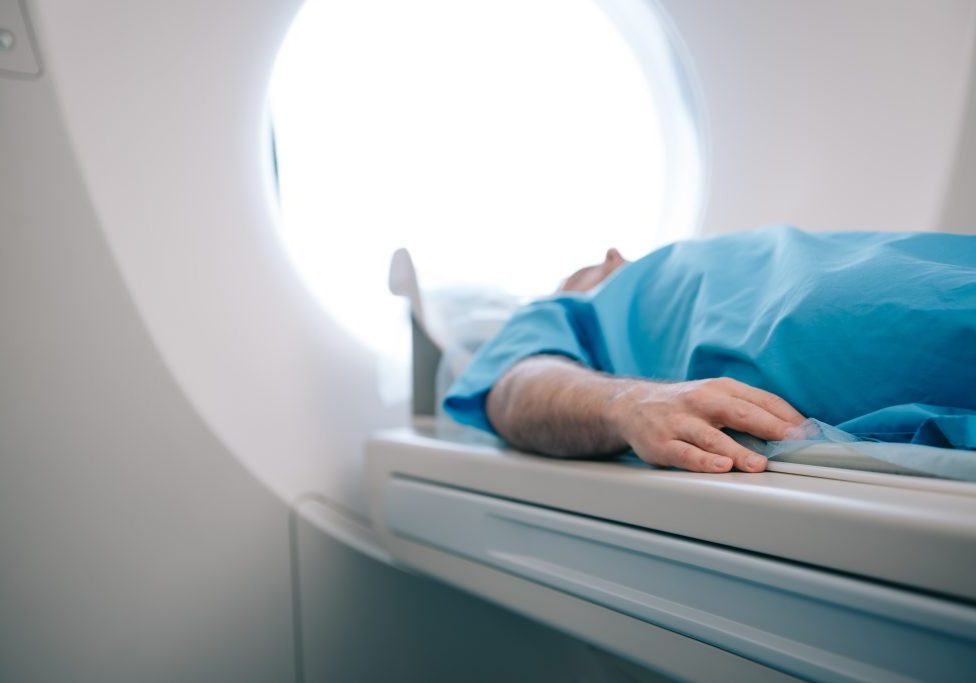 selective focus of patient lying on ct scanner bed during tomography test
